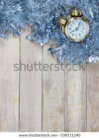 Top view of alarm clock and decorations on wooden background