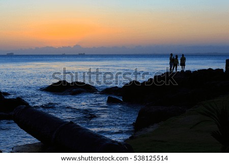 Silhuet of people watching the sunset at Porto da Barra Bahia Brazil