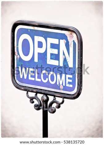 old sign, words open and welcome