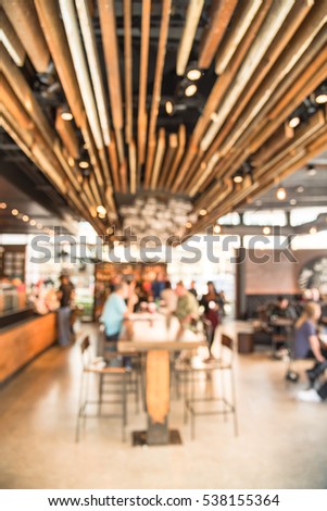 Blurred abstract coffee shop or cafe restaurant in sunny fall morning at Dallas, Texas, US. Blur people, customer waiting for order, pickup and enjoy coffe in bar counter, tables in coffee shop.