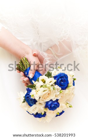 Bouquet in hands of the bride