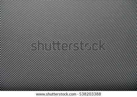 Seamless background is textured gray carbon fiber