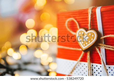 gift is on the table, a garland in the background