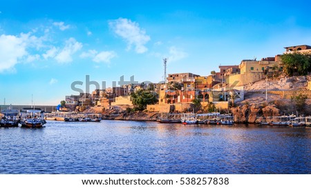 Wooden boats carrying passengers docked along the Nile River at the Temple of Philae in Aswan, Egypt, North Africa Royalty-Free Stock Photo #538257838