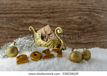 Box with a gift and New Year decorations on white snow