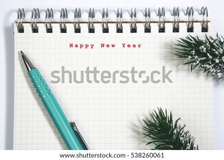 Happy New Year concept, Notebook and green pen, conifer branch