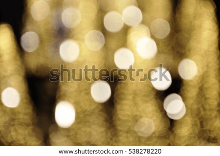 blurred golden light in warm tone background:blur department store shop mall concept ,soft focus dream city.blurry rich golden bubble light wallpaper.orange glitter shine golden bronze display picture