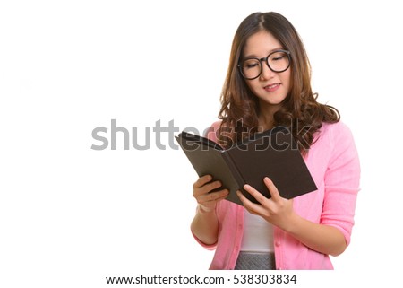 Young happy Asian woman reading book