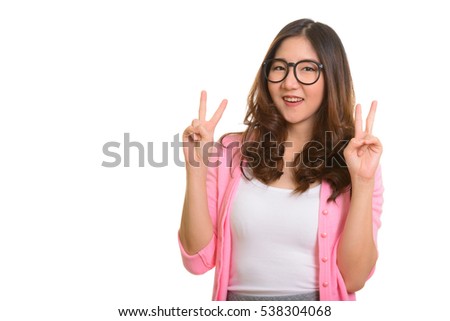 Young happy Asian woman giving peace sign