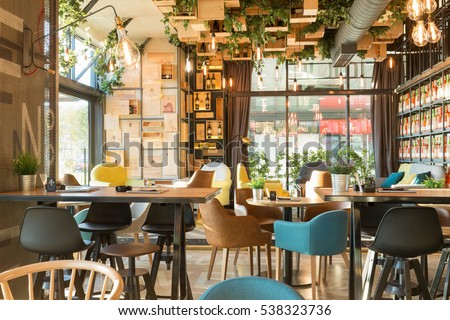 Interior of a modern urban restaurant in the morning sunlight Royalty-Free Stock Photo #538323736