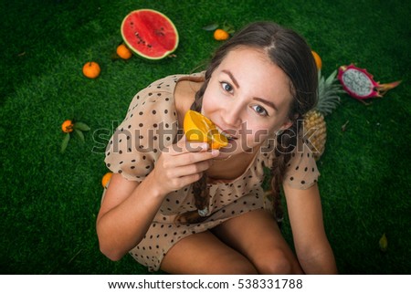 girl on the grass with fruits