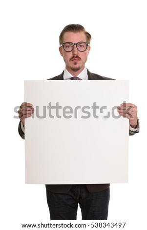 Young handsome Caucasian businessman holding empty white board with copy space