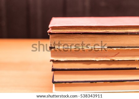 stack of Old books on wooden desk