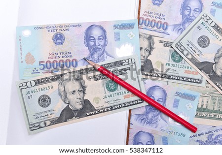 Vietnam and US dollar currency, notebook and pencil