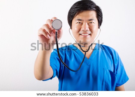 male Asian doctor holding a stethoscope