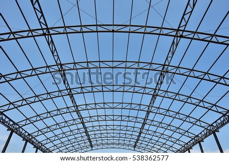 Steel structure roof truss under the construction building in the factory with blue sky
