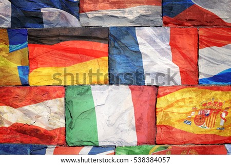 The flags of EU countries drawn on a brick wall