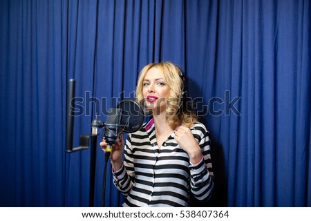 beautiful girl singing in a recording studio