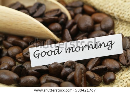 Good morning card with roasted coffee beans, closeup
