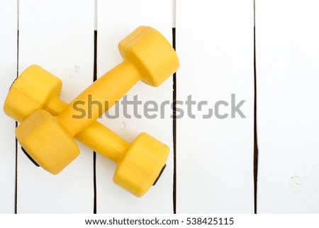 sports ware for gym. Sport concept. Sporting items on white background. Yellow dumbbell. Space for your text. Sports concept. Sport equipment. Fitness