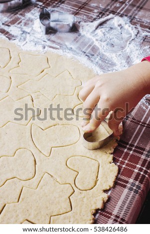 ginger Christmas cookies with their hands.