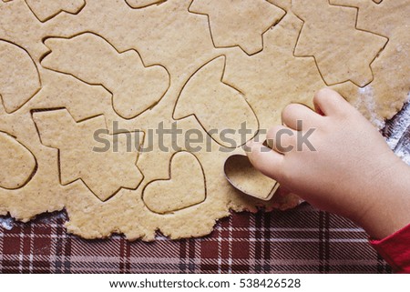 ginger Christmas cookies with their hands.