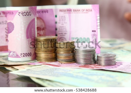 rupee indian currency note Folded As Steps, indian paper currency Two thousand, one hundred rupee note, leading to financial security and savings, coins and cents  Royalty-Free Stock Photo #538428688
