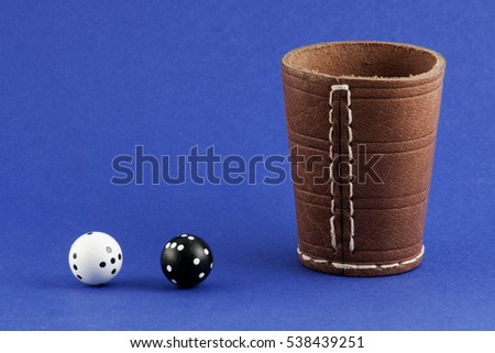 Spherical dice and a glass on a blue background
