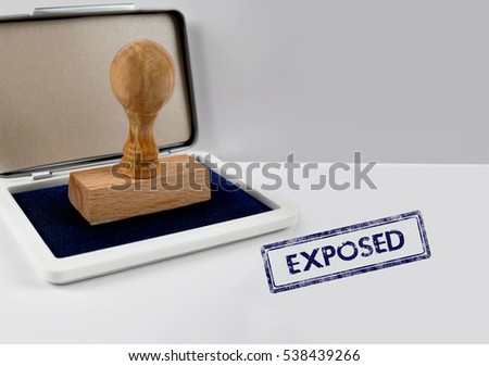 Wooden stamp on a desk EXPOSED