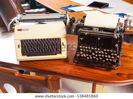 Collection of vintage typewriters in a modern office