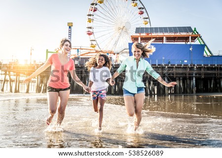 Lesbians mothers with adopted child - Happy homosexual family playing with her daughter Royalty-Free Stock Photo #538526089