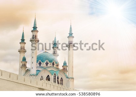 Beautiful white mosque with blue roof against the sky with clouds, sunny. Toned Royalty-Free Stock Photo #538580896