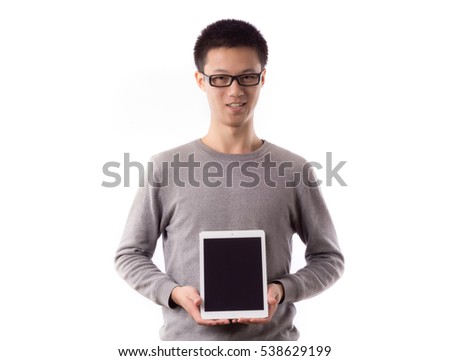 Yound man holding and shows touch screen tablet pc.