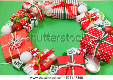 Christmas presents in red packaging. Satin colored ribbons. Green background.