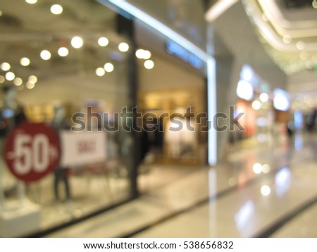Abstract blur beautiful luxury shopping mall with people and retail store interior for background