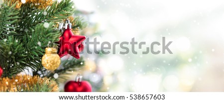 Close up of colorful ornaments on Christmas tree, panoramic banner background