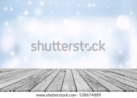 abstract blurred bokeh in bright color and snowflakes fall backdrop with vintage grungy wood tabletop for show and advertise products on display.