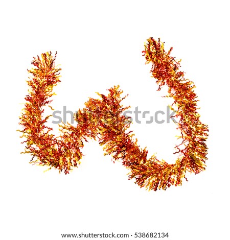 Festive alphabet made of red and yellow tinsel. Letter W on white background. Isolated