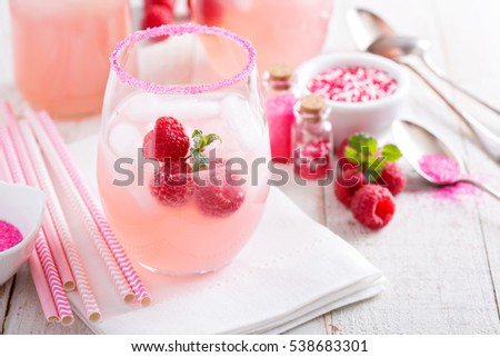 Red raspberry lemonade or cocktail in glasses with sugared rim