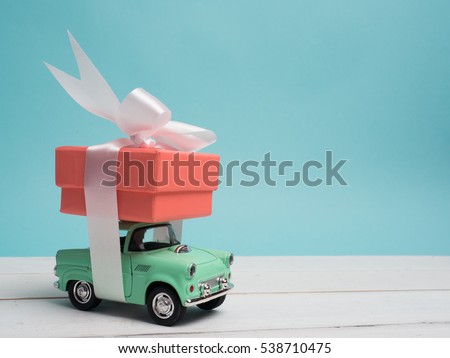 Colorful gift box warp white ribbon and decoration  object and cute vintage car on pastel color background for Christmas and The New Year 2017. Royalty-Free Stock Photo #538710475