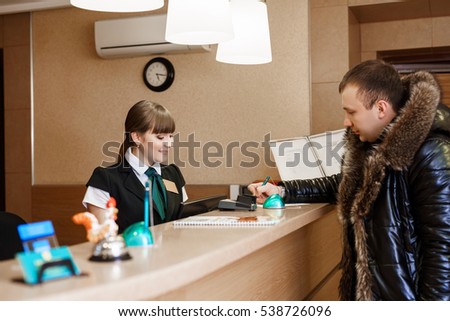 Male guest at hotel reception  during check-in