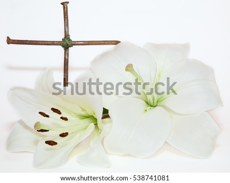 metal  crucifix and Easter white Lily  on  white background