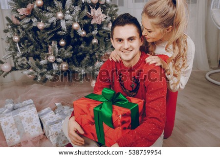 loving couple decorating Christmas tree. give gifts