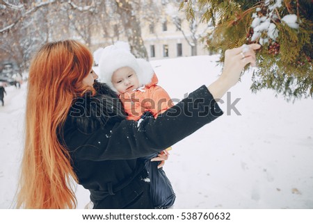 Mother and daughter sitting in a cafe, tea and pyut walking in a winter city