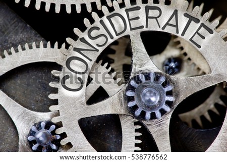 Macro photo of tooth wheel mechanism with CONSIDERATE concept letters