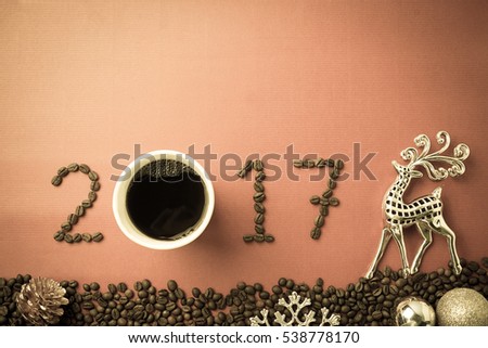 2017 coffee bean text and christmas decoration on red craft paper for new year concept background