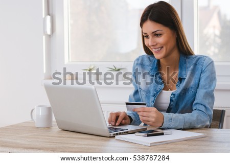 Shot of a women holding a credit card and purchasing online Royalty-Free Stock Photo #538787284