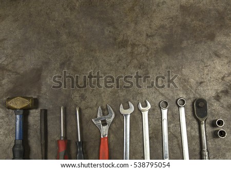 Mechanic tools on the metal background