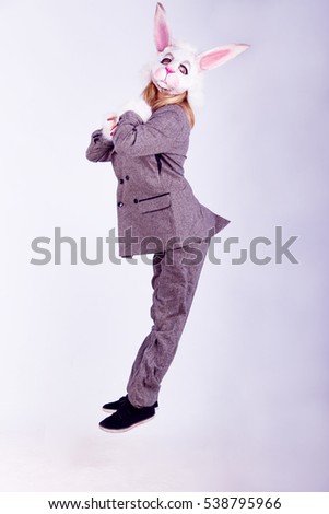 Young woman wearing the mask of rabbit posing isolated on white background