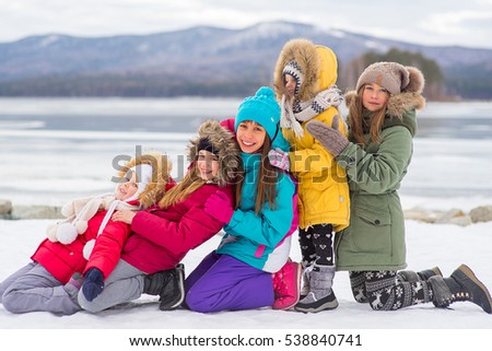Group of young girls who walks outdoors on the frozen lake
